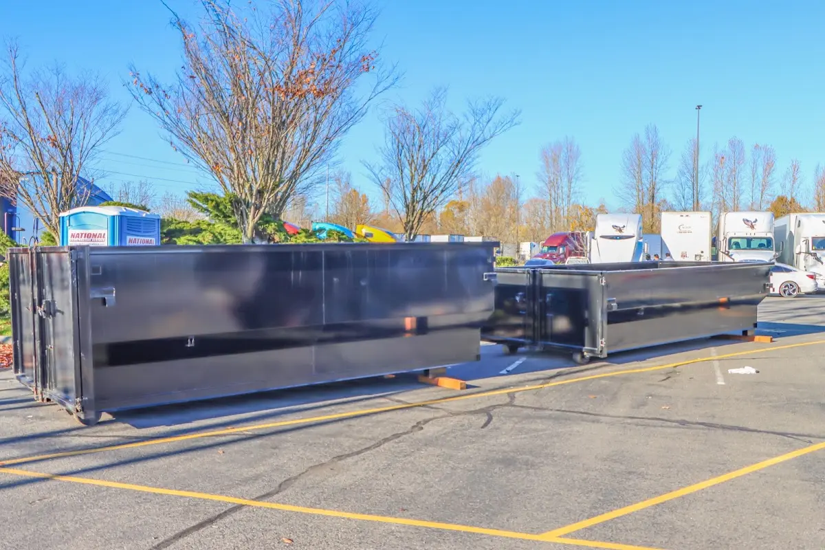 Professional dumpster rental service with roll-off container on residential driveway in Lemoore Station